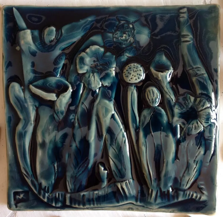 Ceramic art with abstract figures in blue tones.