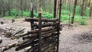 Wooden structure in a forest clearing.