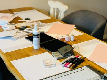 A table full of craft materials and paper.
