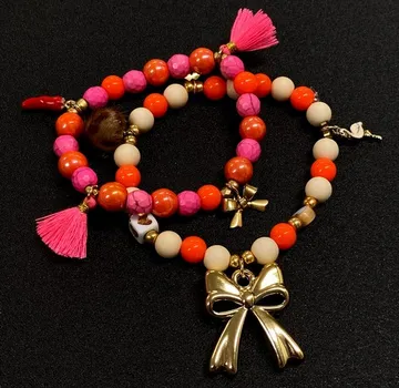 Colorful beaded bracelets with gold bow charms.