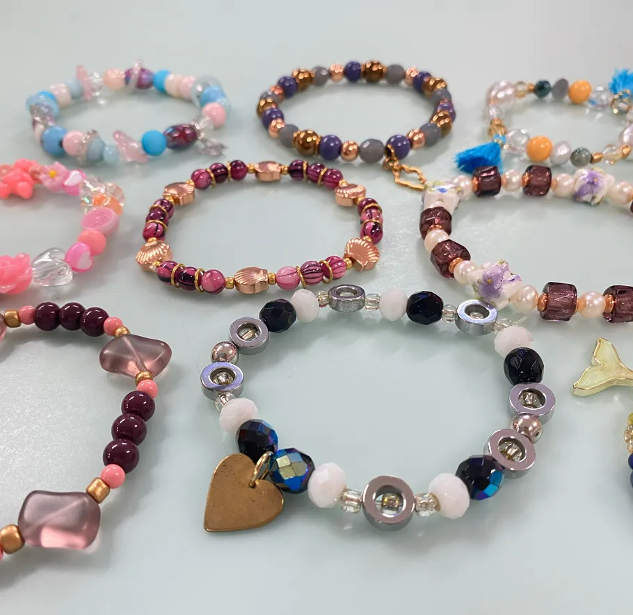 Colorful beaded bracelets displayed on table.
