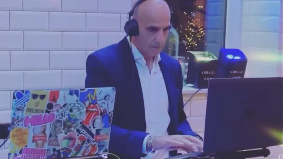 DJ mixing music in a modern room.