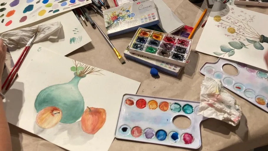 Artists painting still life with watercolors.