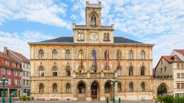 Historic building with clock tower, clear sky.