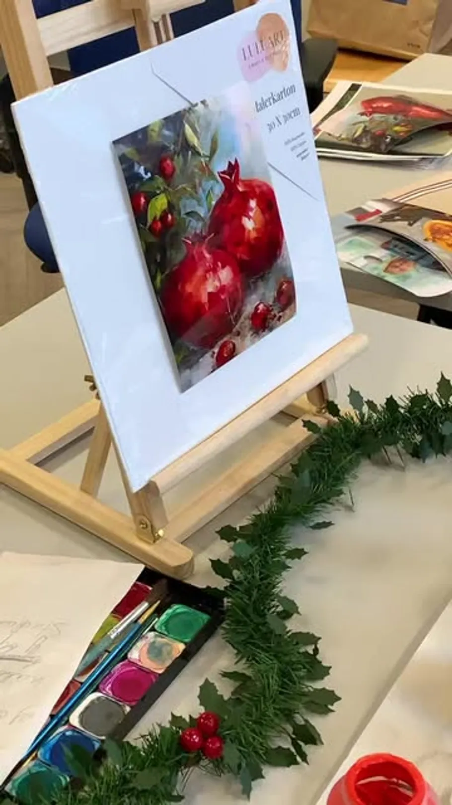 Painting of pomegranates on display in art studio.