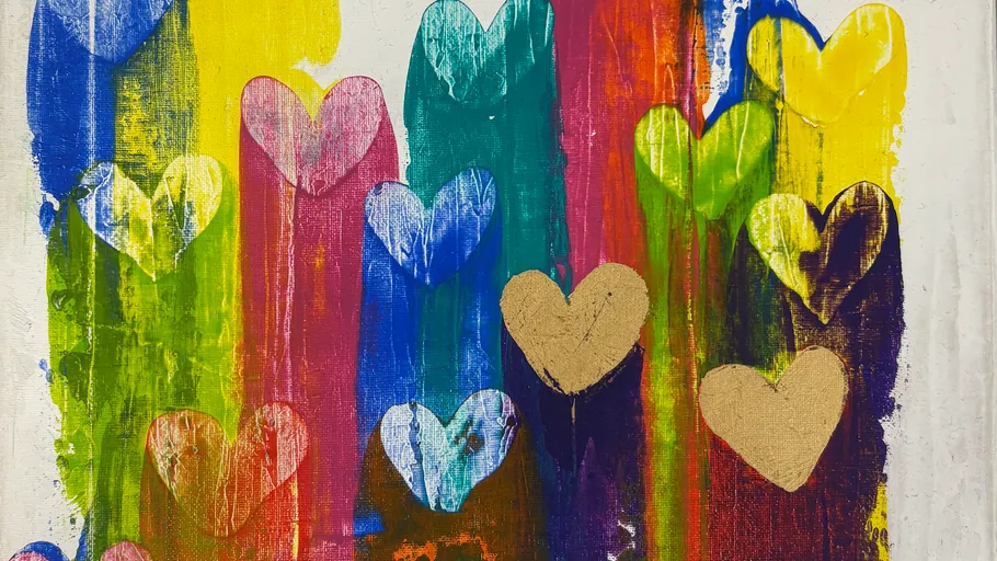 Colorful hearts painted on textured surface.