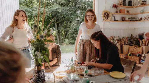 Women crafting together inside a cozy room.