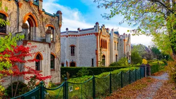 Historic castle-like building with garden path.