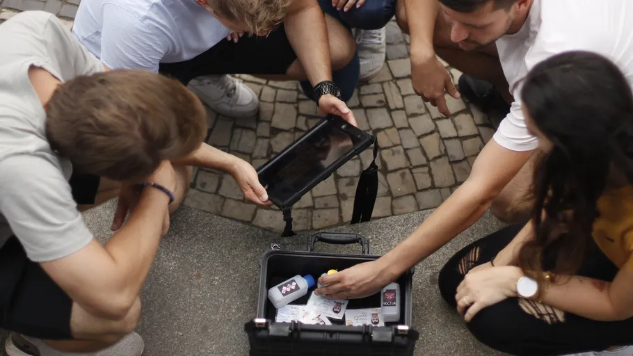People examining items in an open case.