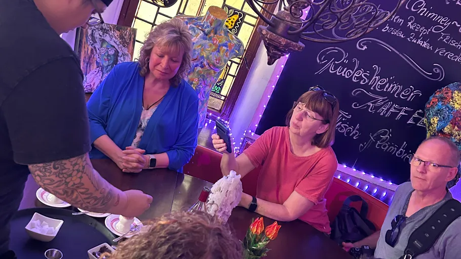 People gathered around a table, participating in activity.