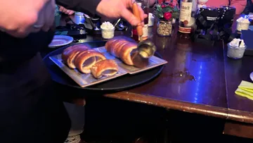 Pastries being served at a restaurant table.