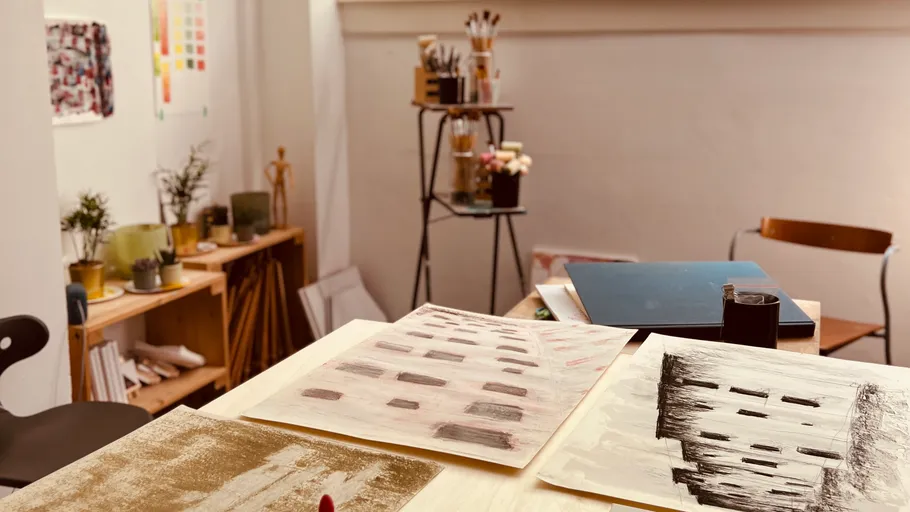 Art studio with paintings on table.