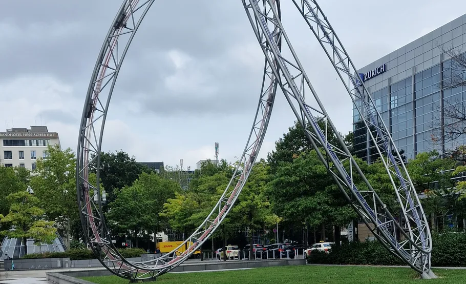 Sculpture on grass with cloudy sky background.