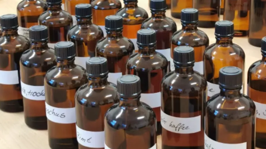 Brown bottles with labels on a table.