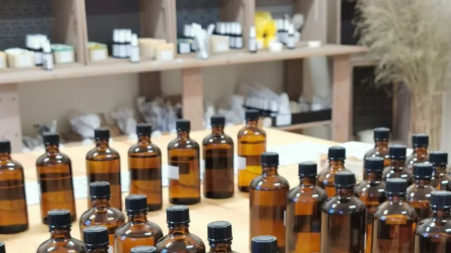 Brown bottles on a wooden table in a shop.