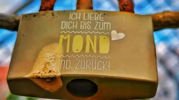 Rusty love lock with engraved message.