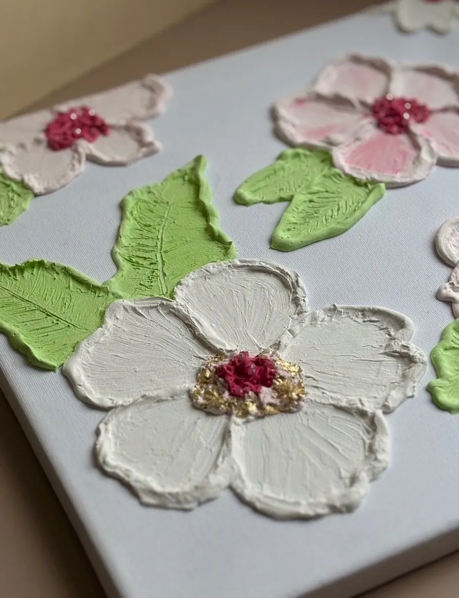 Textured flowers and leaves on canvas.