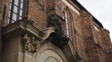 Brick church facade with decorative sculptures.