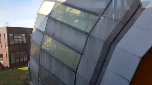 Modern building with large glass panels.