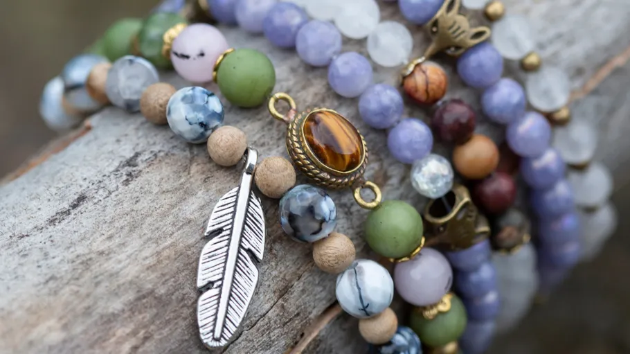 Beaded bracelets with charms on wood.