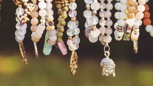 Colorful beaded bracelets hanging outdoors.