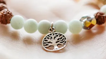 Beaded bracelet with a tree pendant.
