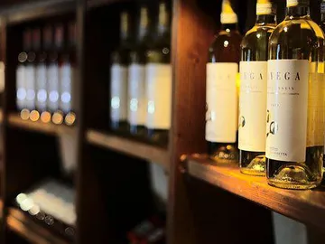 Wine bottles are neatly placed on a wooden rack.
