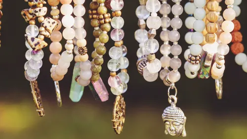 Various beaded bracelets hanging closely together.