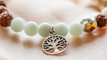 Beaded bracelet with tree pendant, close-up.