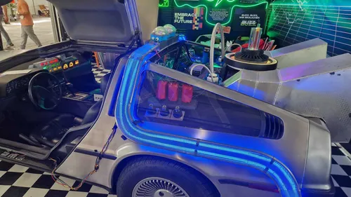 Futuristic car with open gullwing door, neon lights.