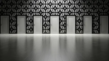 Six closed doors in ornate hallway.