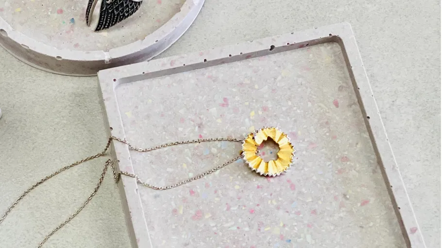Pencil shaving necklace on terrazzo tray.