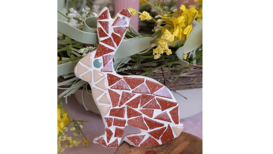 Mosaic rabbit with floral background.