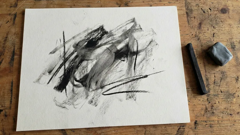 Charcoal abstract drawing on wooden table.
