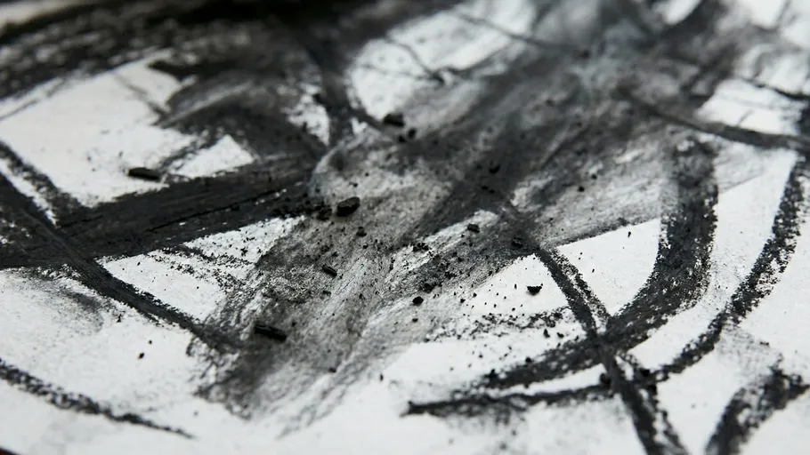 Charcoal sketch with smudged abstract lines.