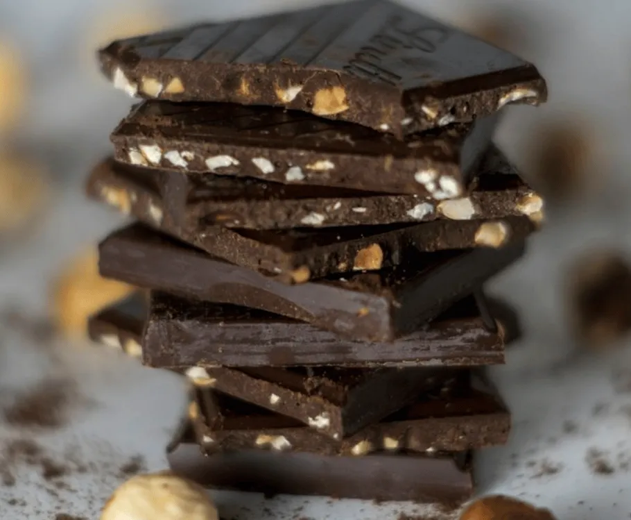 Stack of chocolate pieces with nuts.
