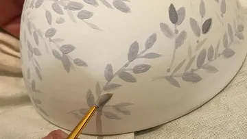 Hand-painted floral design on ceramic bowl.