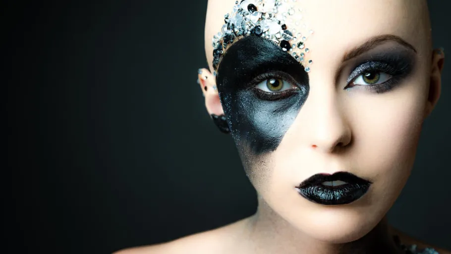 Woman with artistic face makeup gazes forward.