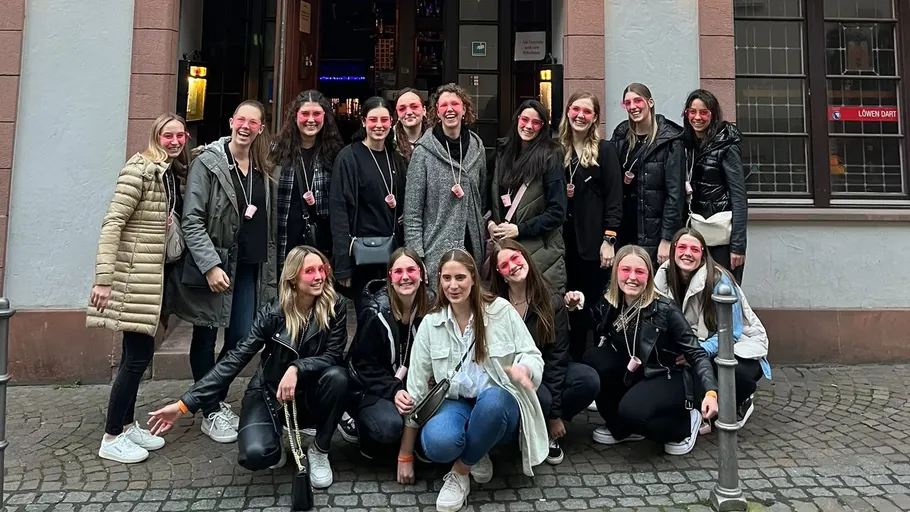 Group of women posing on cobblestone street.