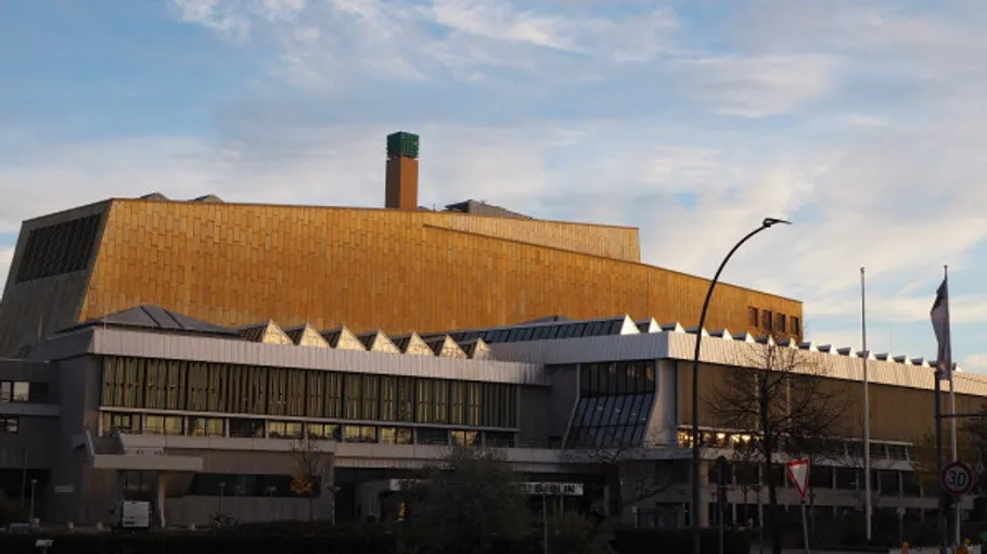 Modern building with gold facade, clear sky.