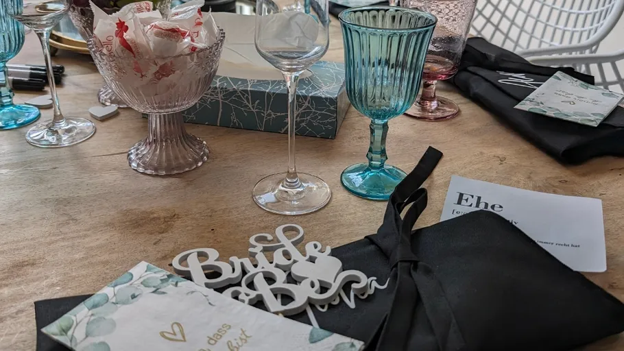 Wedding table with decorations and glassware.