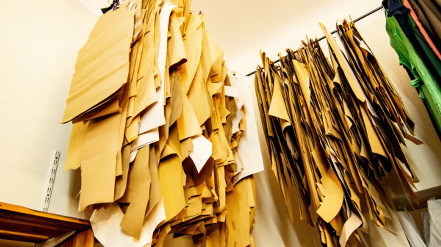 Paper patterns hanging in a sewing room.