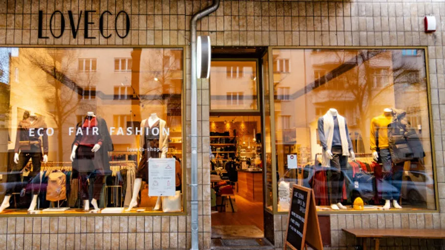 Clothing store exterior with mannequins displayed.