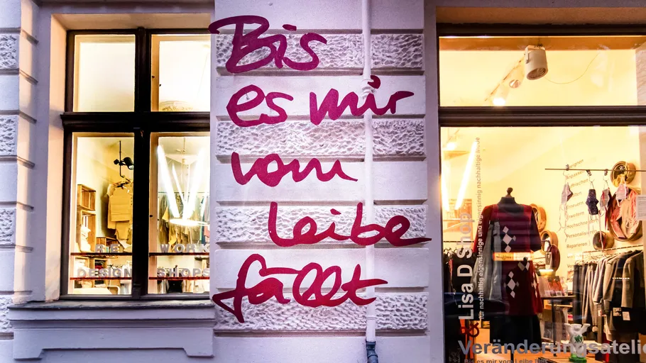 Wall with text beside shop window.