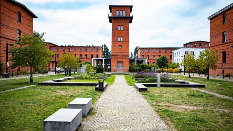 Brick building in center of courtyard area.