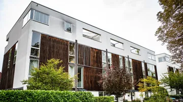 Modern apartment building with wooden facade.