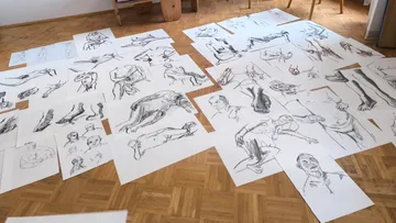 Sketches of figures on floor in living room.