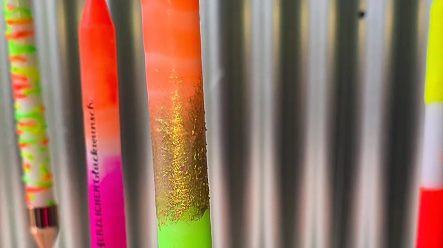 Colorful pencils hanging on metallic background.