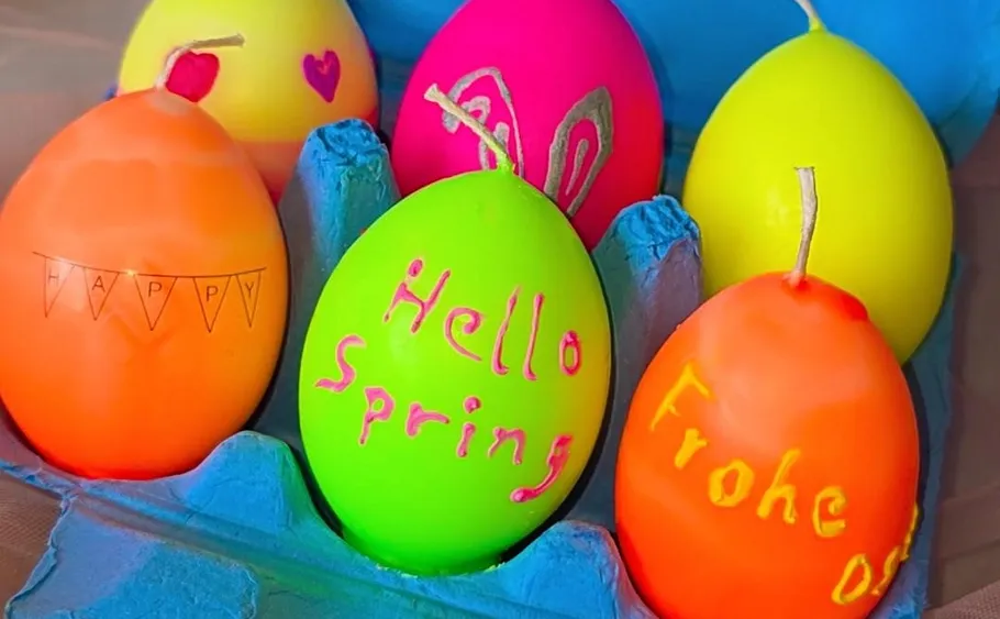 Colorful eggs with text in carton.