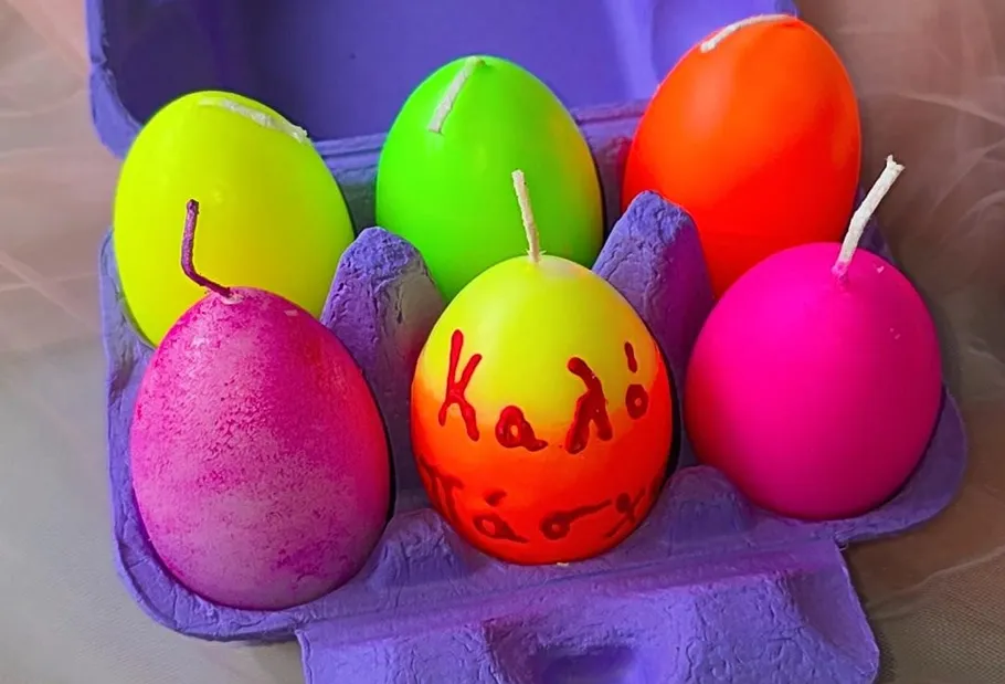 Egg-shaped candles in colorful carton.